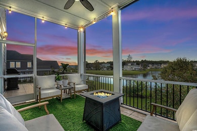 Sunroom featuring a water view, ceiling fan, and r