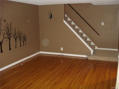 Living room leading to upstairs front staircase.
