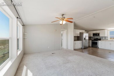 Unfurnished living room with ceiling fan, vaulted 