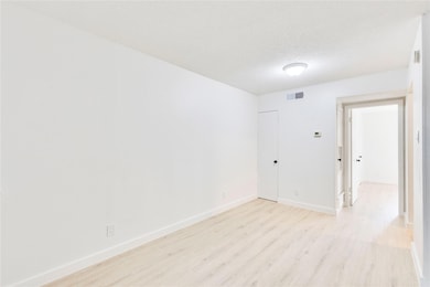 Spare room with light wood-style flooring and a t