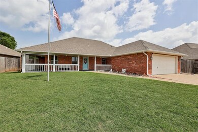 View of front of property with brick siding, covered porch, an attached garage, and a shingled roof