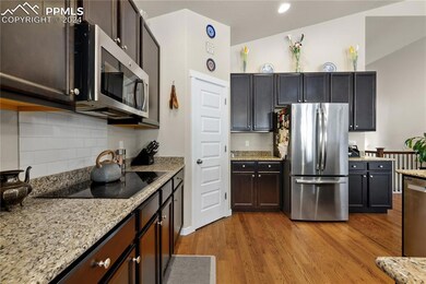 Kitchen with tasteful backsplash, dark brown cabin