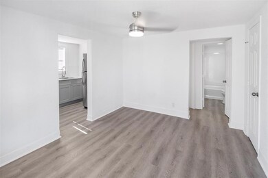 Bright, modern room featuring light wood flooring,