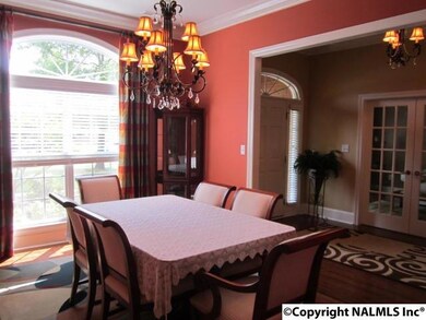Entertain in the Formal Dining Room with hardwoods, crown moulding, and beautiful palladium window with abundant natural lighting.