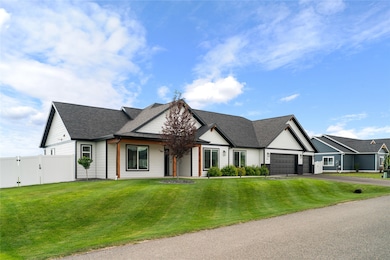 View of front of home with a gate, roof with shingles, asphalt driveway, and an attached garage