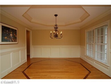 Dining Room. Formal Dining Room with custom trey ceiling, inlaid wood floor, extensive molding and neutral paint.