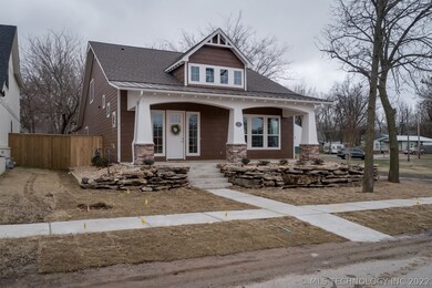 Limestone Boulders Accent the Front of the Home &