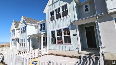 View of front of house featuring board and batten siding, a fenced front yard, and covered porch (pictures are of a previous home built)