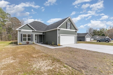 View of front of property with a front lawn, drive