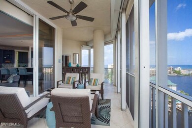 Balcony featuring a water view and ceiling fan