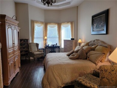 Huge master bedroom with hardwood floors.