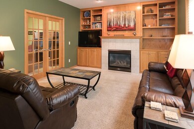 Living room gas fireplace is flanked by built-ins.