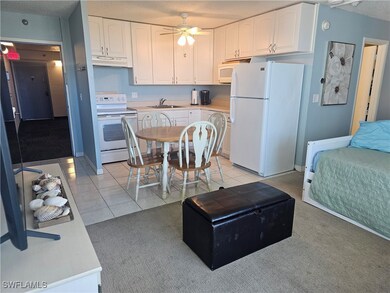 Kitchen featuring white appliances, a sink, under
