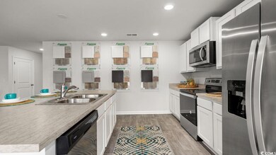 Kitchen featuring visible vents, white cabinets, s