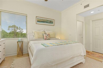Bedroom with crown molding, light hardwood / wood-