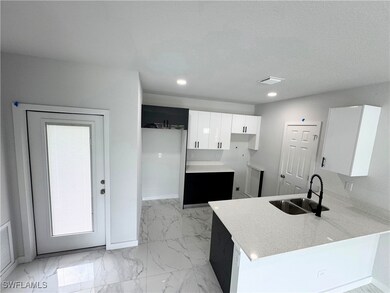 Kitchen featuring a peninsula, light marble finish