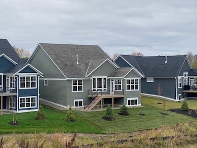 Charming Villa with HOA lawn care and snow removal. Large azek covered front porch. Beautiful exterior! Landscaping sod & irrigation now completed. Azek deck & stairs and abundance of windows with pond views.