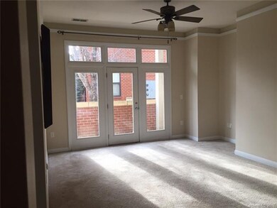 Carpeted Living Room with door leading to the priv