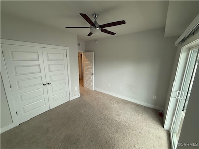 Unfurnished bedroom featuring carpet, a closet, ba