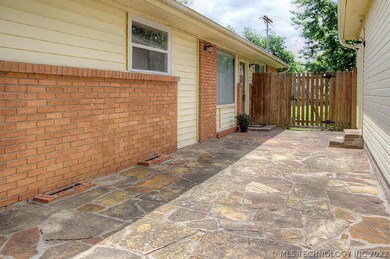 Flagstone walkway to entry of home and detached ga