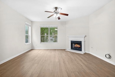 Unfurnished living room with wood finished floors