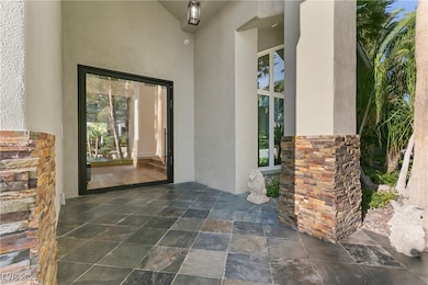 Doorway to property with a patio area