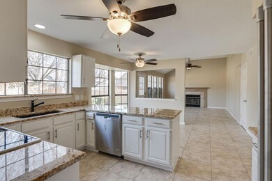 Kitchen open to breakfast area and family room with views of backyard
