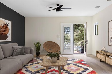 Living room featuring light wood-style floors and ceiling fan