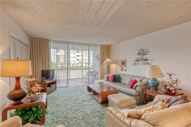 Large living room with sliders to screened patio