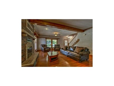 Spacious great room with lovely hardwoods.