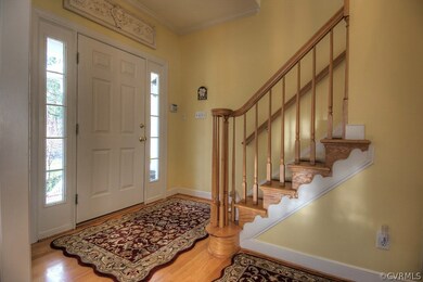 Foyer features include hardwood floors and crown m
