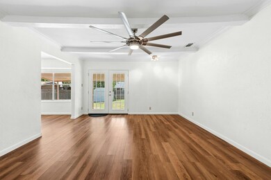 Empty room with crown molding, french doors, wood