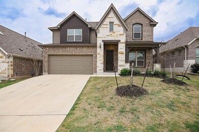 View of front of house featuring stone siding, an
