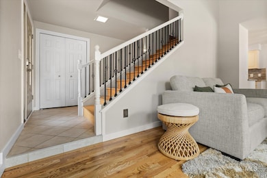 Foyer featuring light wood-style flooring and stairs