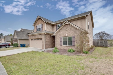Craftsman house with driveway, an attached garage, brick siding, and a shingled roof