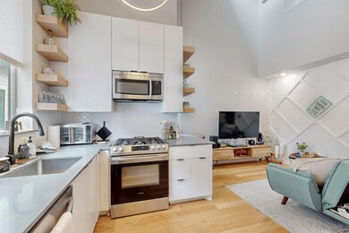 Kitchen featuring open shelves, appliances with s