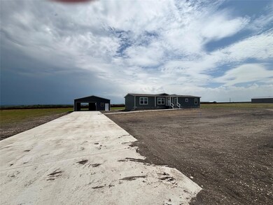 Single story home featuring an outbuilding, concr