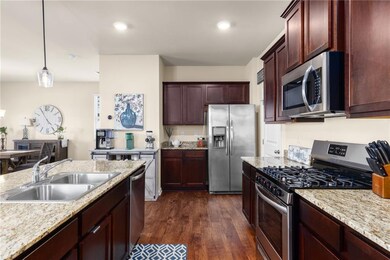 Neutral light stone counters, a stainless steel si
