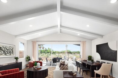 Great room with vaulted ceiling and white-painted ceiling beams