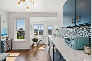 The updated eat-in kitchen is bathed in light and 