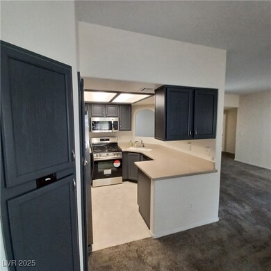 Kitchen featuring light countertops, a sink, visib