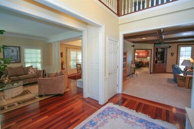 Foyer, living room, and dining room all with Brazi
