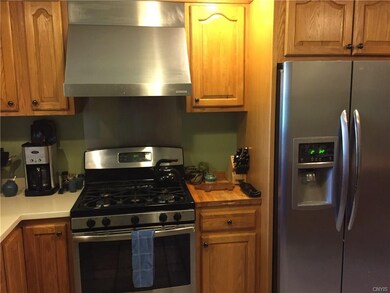 stainless range and hood in this large kitchen