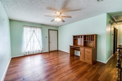 Unfurnished living room featuring dark wood-type f