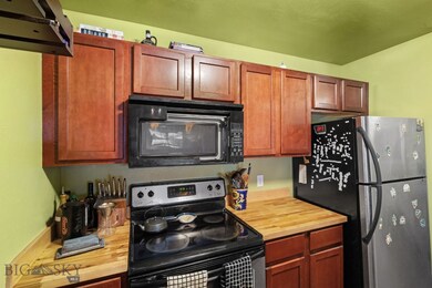 Kitchen with butcher block counter top.
