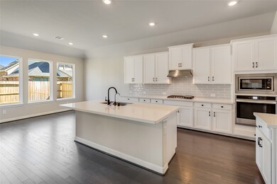 This kitchen is by far any chef’s dream! This spacious kitchen features large windows, high ceilings, white stained wood cabinets, quartz countertops, SS appliances, modern tile backsplash, recessed lighting, extended counter space, large kitchen island with space for breakfast bar, and a walk-in pantry all overlooking your huge family room.
