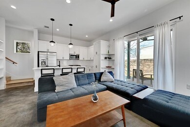 Living room with visible vents, stairs, finished 