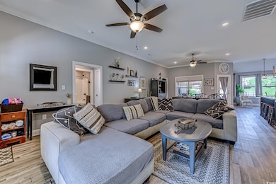 Living area with visible vents, ornamental molding