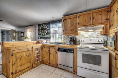 Kitchen with light tile patterned floors, white ra