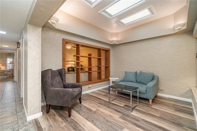 Sitting room featuring a textured wall, wood finis